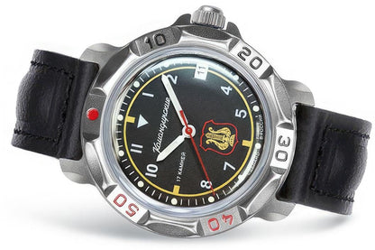 Vostok Komandirskie 81642B - close-up diagonal view of black dial, military orchestra emblem, case and black leather strap