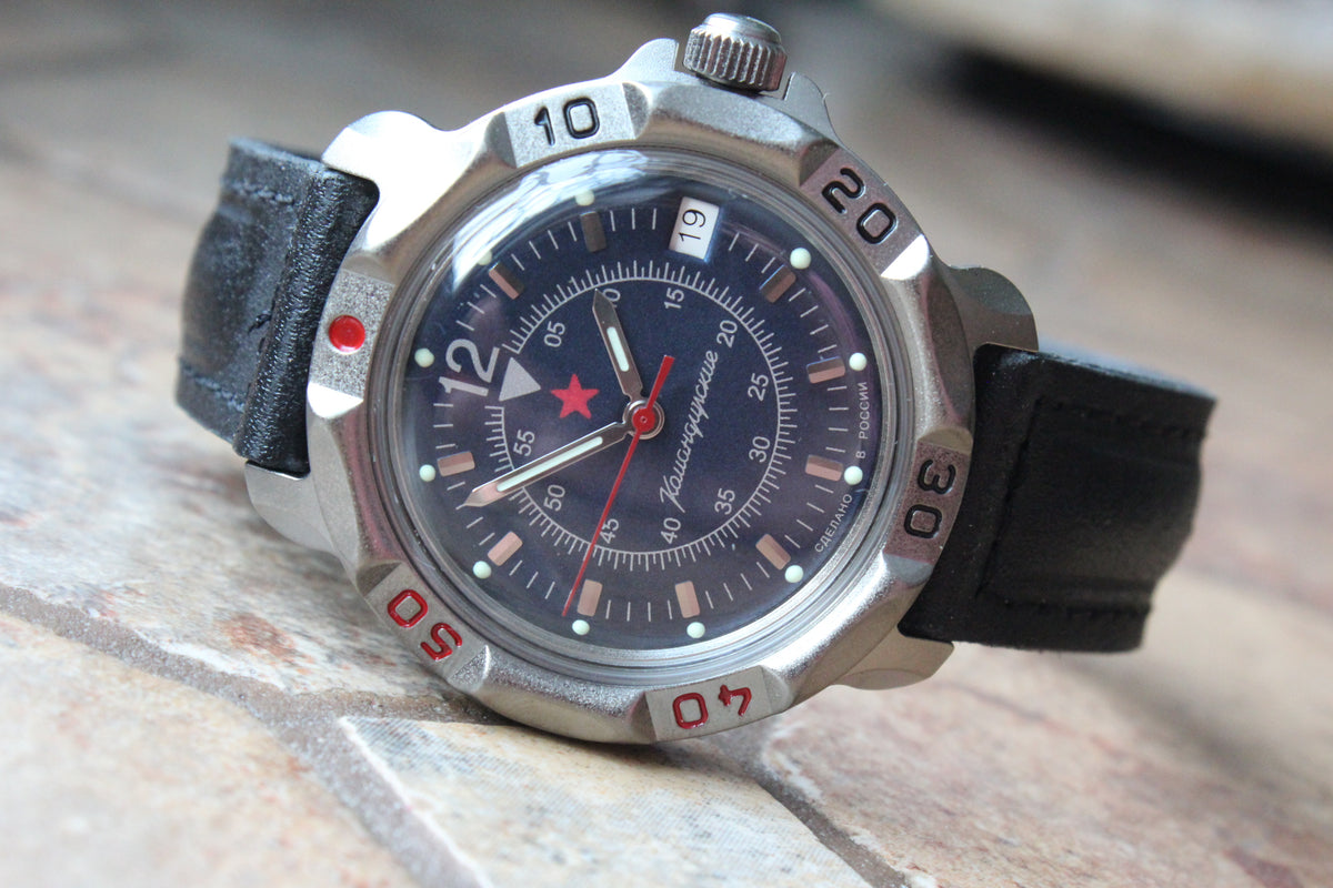 Vostok Komandirskie 816398 - diagonal front view with dark blue military emblem dial, complete case and crown, 12 oclock toward upper left