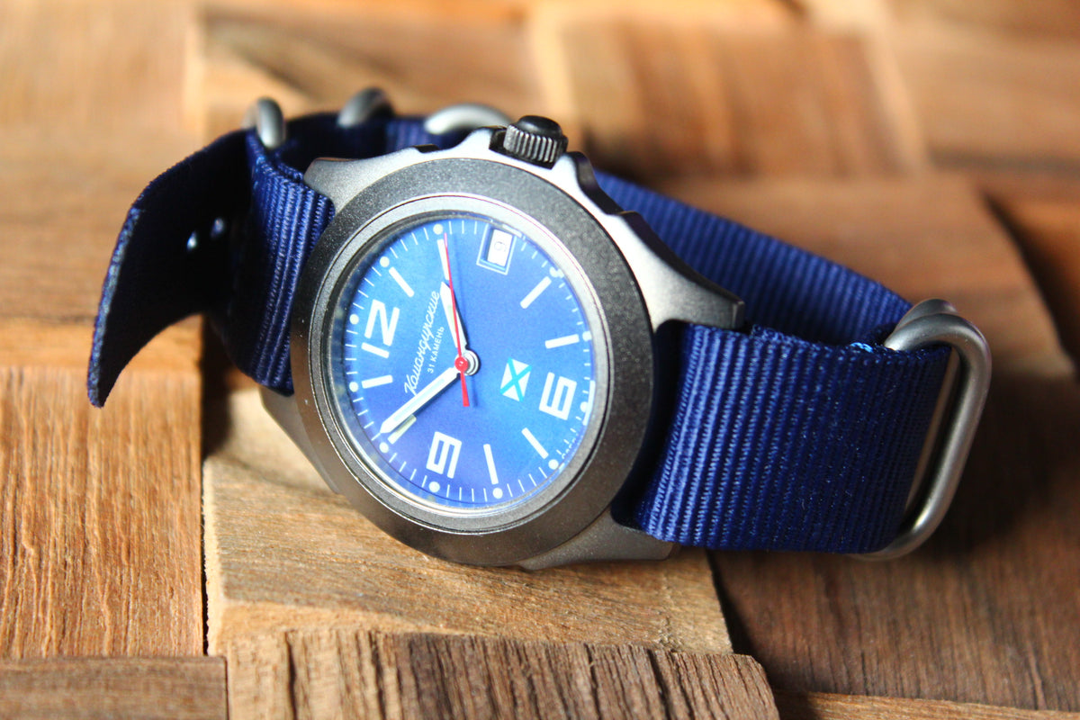Vostok Komandirskie 30601G - diagonal front view with blue dial and curved blue nylon strap