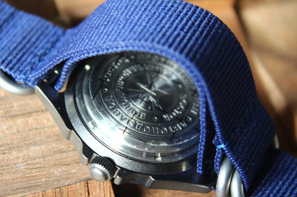 Vostok Komandirskie 30601G - engraved case back beneath blue nylon strap