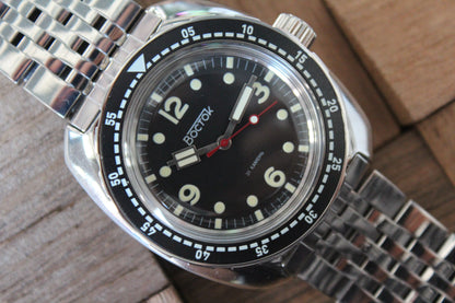 Vostok Amphibia 71067A - close-up of black dial, bezel and stainless steel bracelet