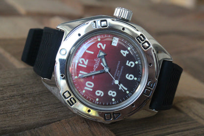 Vostok Amphibia 67069B - diagonal front view with red dial, complete case and black strap