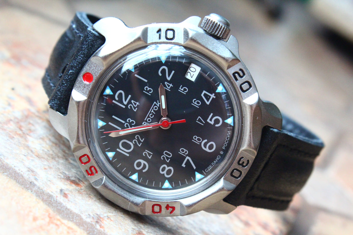 Vostok Komandirskie 816783 - diagonal front view with black military emblem dial, complete case and crown, 12 oclock toward upper left