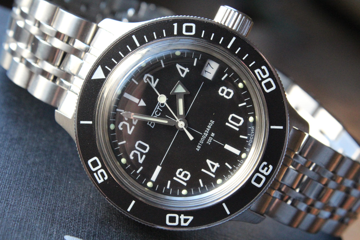 Vostok Amphibia 720076 - diagonal front view with black dial, complete case and crown