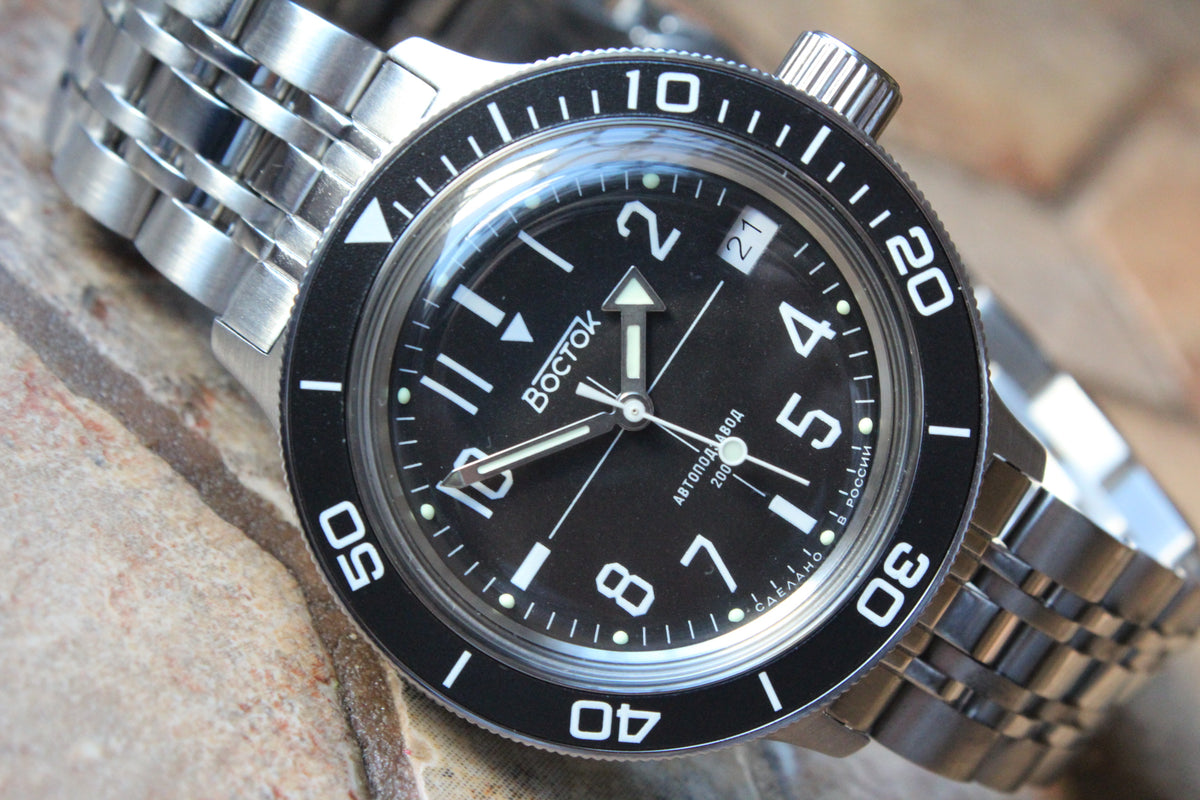 Vostok Amphibia 720073 - diagonal front view with black dial, complete case and crown