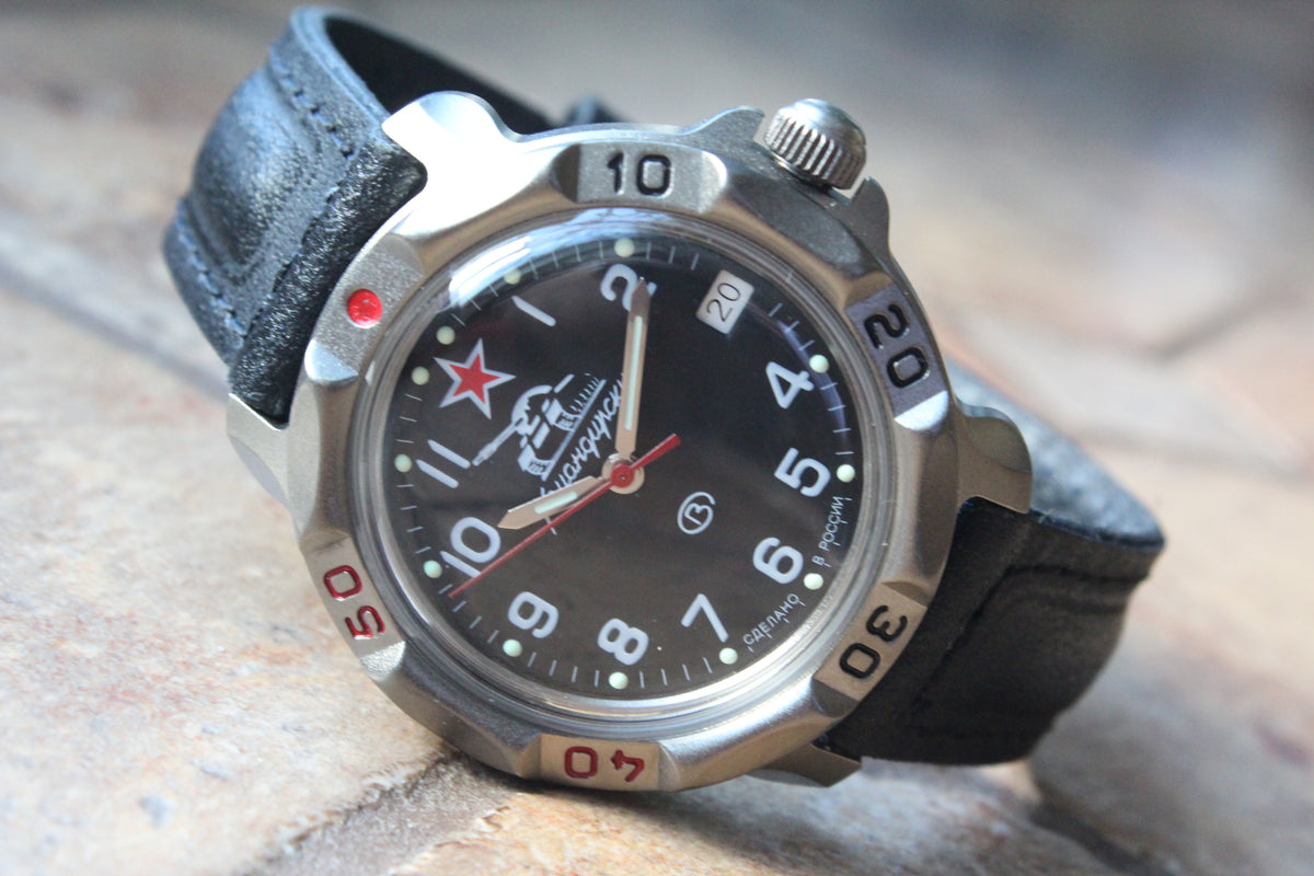 Vostok Komandirskie 816306 - diagonal front view with black tank emblem dial, complete case and crown, 12 oclock toward upper left