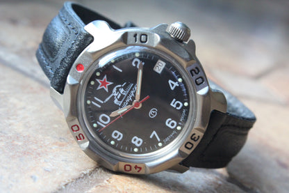 Vostok Komandirskie 816306 - diagonal front view with black tank emblem dial, complete case and crown, 12 oclock toward upper left