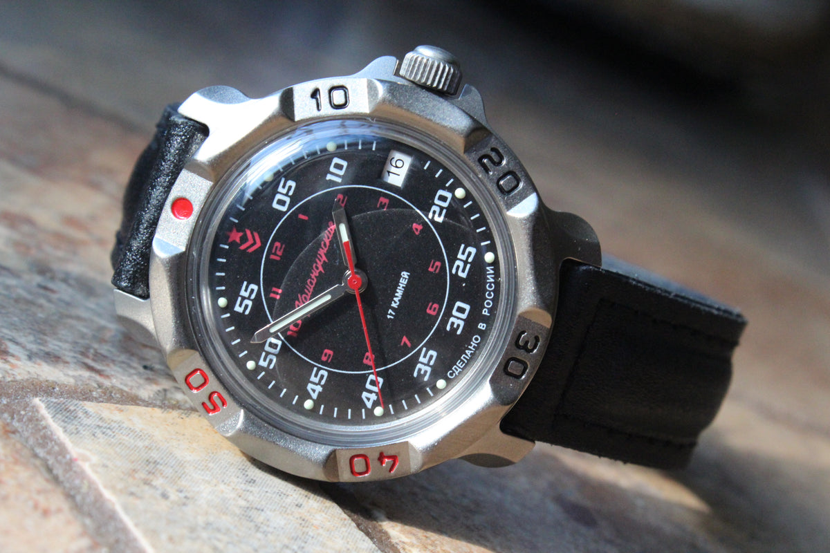 Vostok Komandirskie 816172 - diagonal front view with black and red military dial, complete case and crown, 12 oclock toward upper left