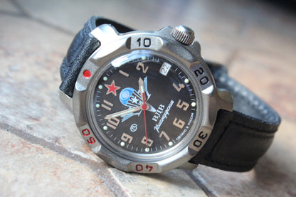 Vostok Komandirskie 816288 - diagonal front view with black paratrooper emblem dial, complete case and crown, 12 oclock toward upper left