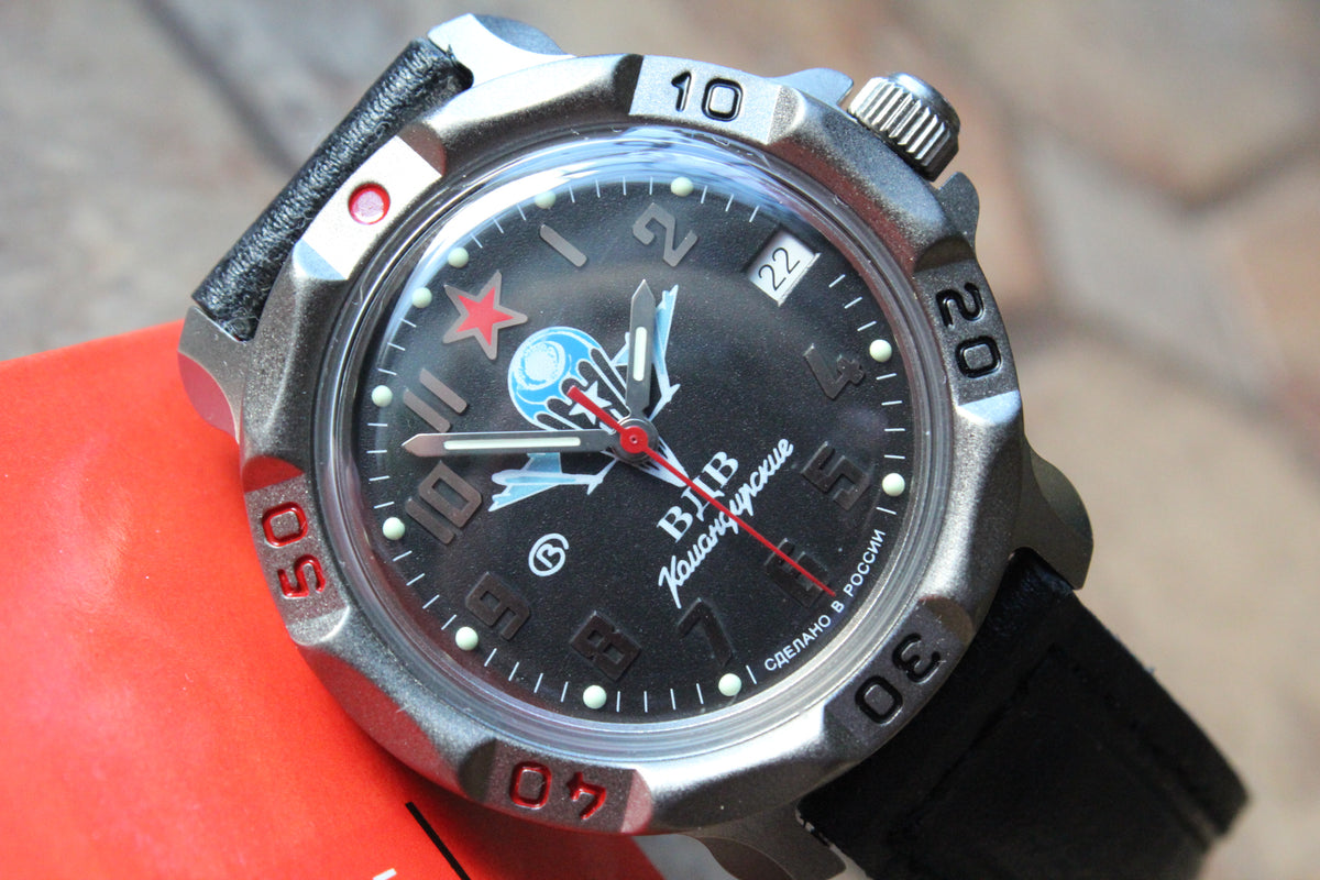 Vostok Komandirskie 816288 - close-up of black paratrooper emblem dial, date window and bezel