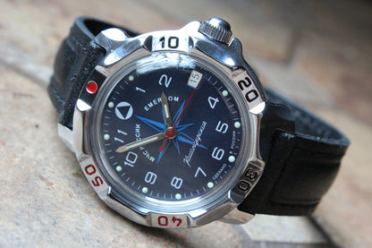 Vostok Komandirskie 811942 - diagonal front view with blue EMERCOM emblem dial, complete case and crown
