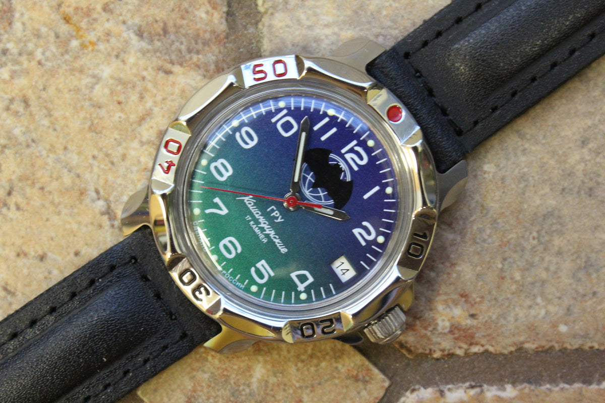 Vostok Komandirskie 811873 - close-up of blue and green bat emblem dial and bezel