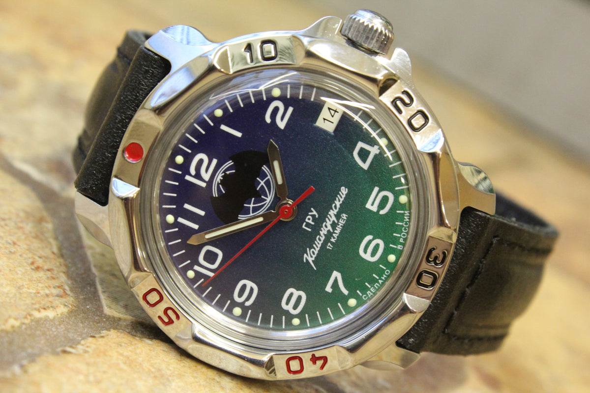 Vostok Komandirskie 811873 - diagonal front view with blue and green bat emblem dial, complete case and crown