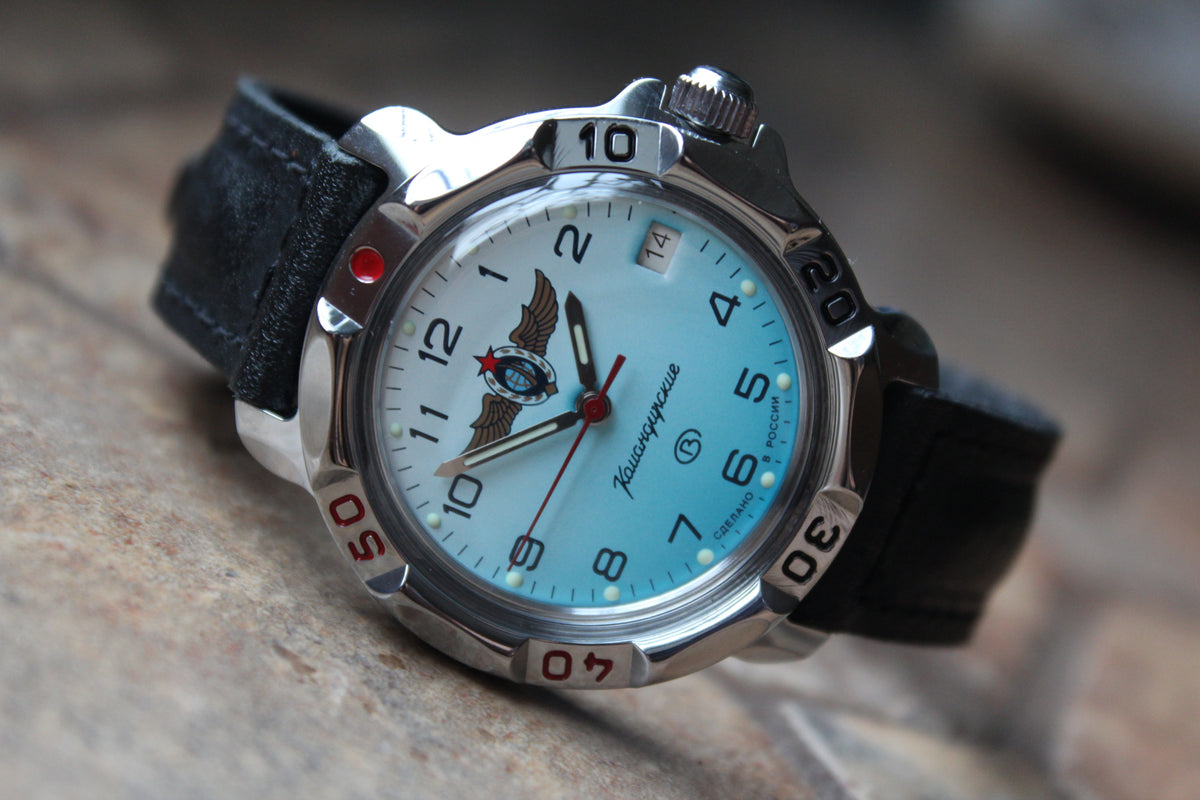 Vostok Komandirskie 811958 - diagonal front view with light blue winged emblem dial, complete case and crown, 12 oclock toward upper left