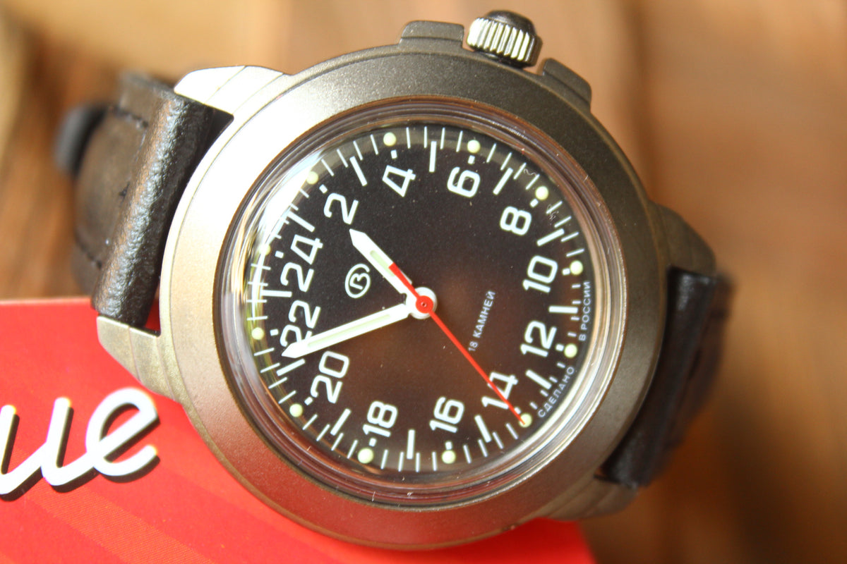 Vostok Komandirskie 43622G - close-up of black 24-hour dial and winding crown